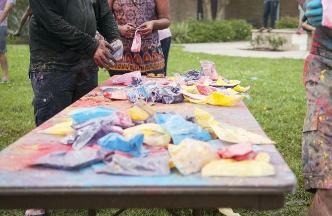 Students throw colored dye to celebrate Holi festival