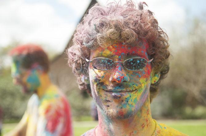 Students throw colored dye to celebrate Holi festival