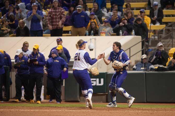 LSU senior catcher Kellsi Kloss (77) high fives LSU pitcher LSU sophmore pitcher Carley Hoover (21) after her third consecutive strikeout during their 2-1 defeat against University of the Pacific on Saturday, Feb. 13, 2016 at Tiger Park