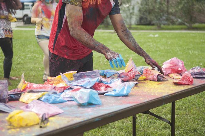 Students throw colored dye to celebrate Holi festival