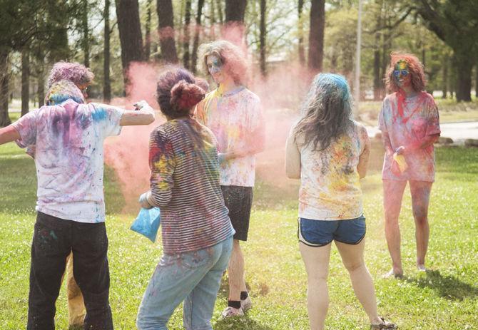 Students throw colored dye to celebrate Holi festival