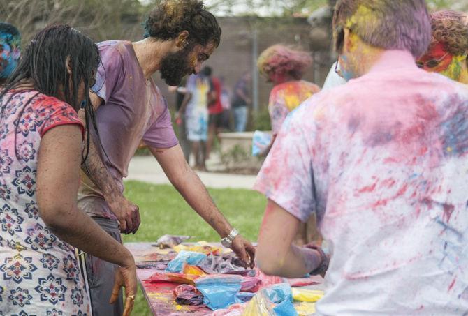 Students throw colored dye to celebrate Holi festival