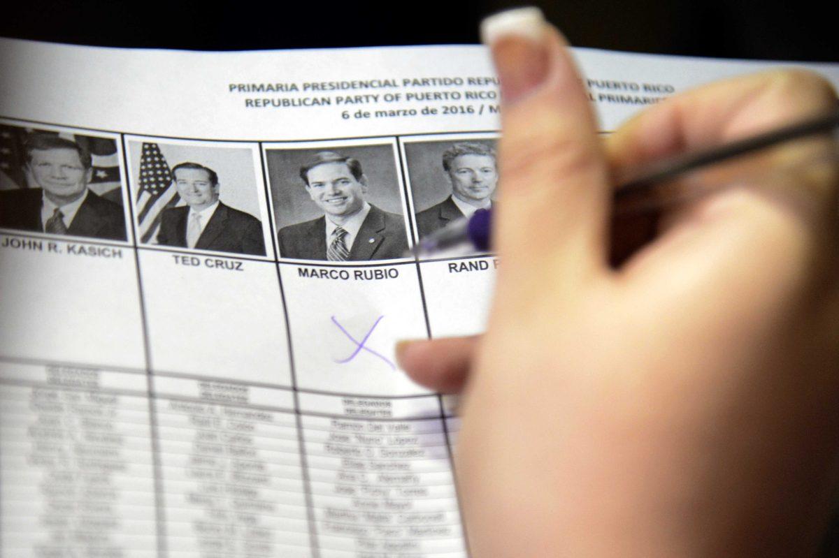 A woman marks her vote for Florida's Senator Marco Rubio during Puerto Rico's Republican primary in San Juan, Puerto Rico, Sunday March 6, 2016 . Puerto Rico residents cannot participate in general presidential elections but can do so in primaries. Puerto Rico sends 20 delegates to the Republican convention.(AP Photo/Carlos Giusti)