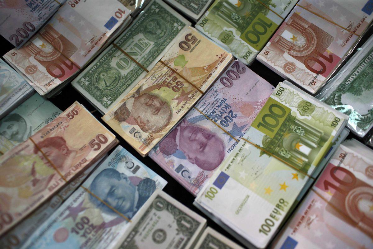 FILE - In this Monday, June 8, 2015, file photo, Turkish liras, euros and U.S. dollars are stacked at a currency exchange office in Istanbul, Turkey. Investors are now seeing the downside of one of 2015's hottest investing trends: Exchange-traded funds that invest in foreign stocks while trying to eliminate the threat of changing currency values. The dollar has been falling against other currencies, which gives a boost to traditional funds that don&#8217;t &#8220;hedge&#8221; against currency values. (AP Photo/Emrah Gurel, File)