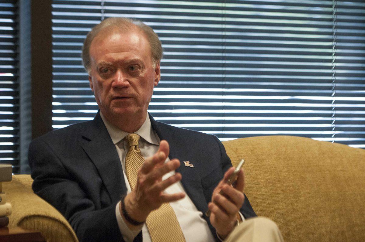 Secretary of State Tom Schedler holds up his personal iPhone as he explains Geauxvote.com on Friday, Sept. 25, 2015, in his office.