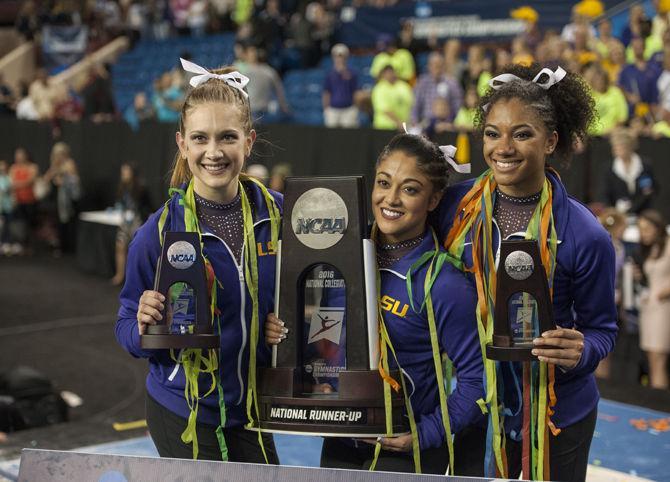 LSU all-arounder seniors Jessica Savona, Randii Wyrick and Michelle Gauthier celebrate during the Tigers 197.4500 score for second place in the National Championship on Saturday, Apr. 16, 2016 in Dallas Fort Worth.