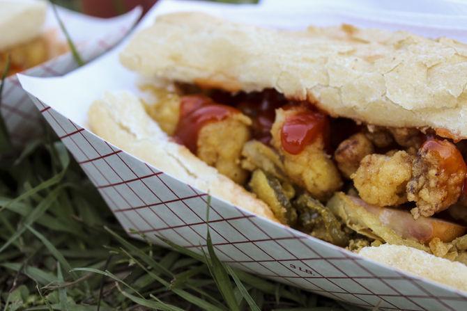 Food vendors sell alligator po-boys Friday, April 22, 2016 during the first day of the New Orleans Jazz &amp; Heritage Festival.