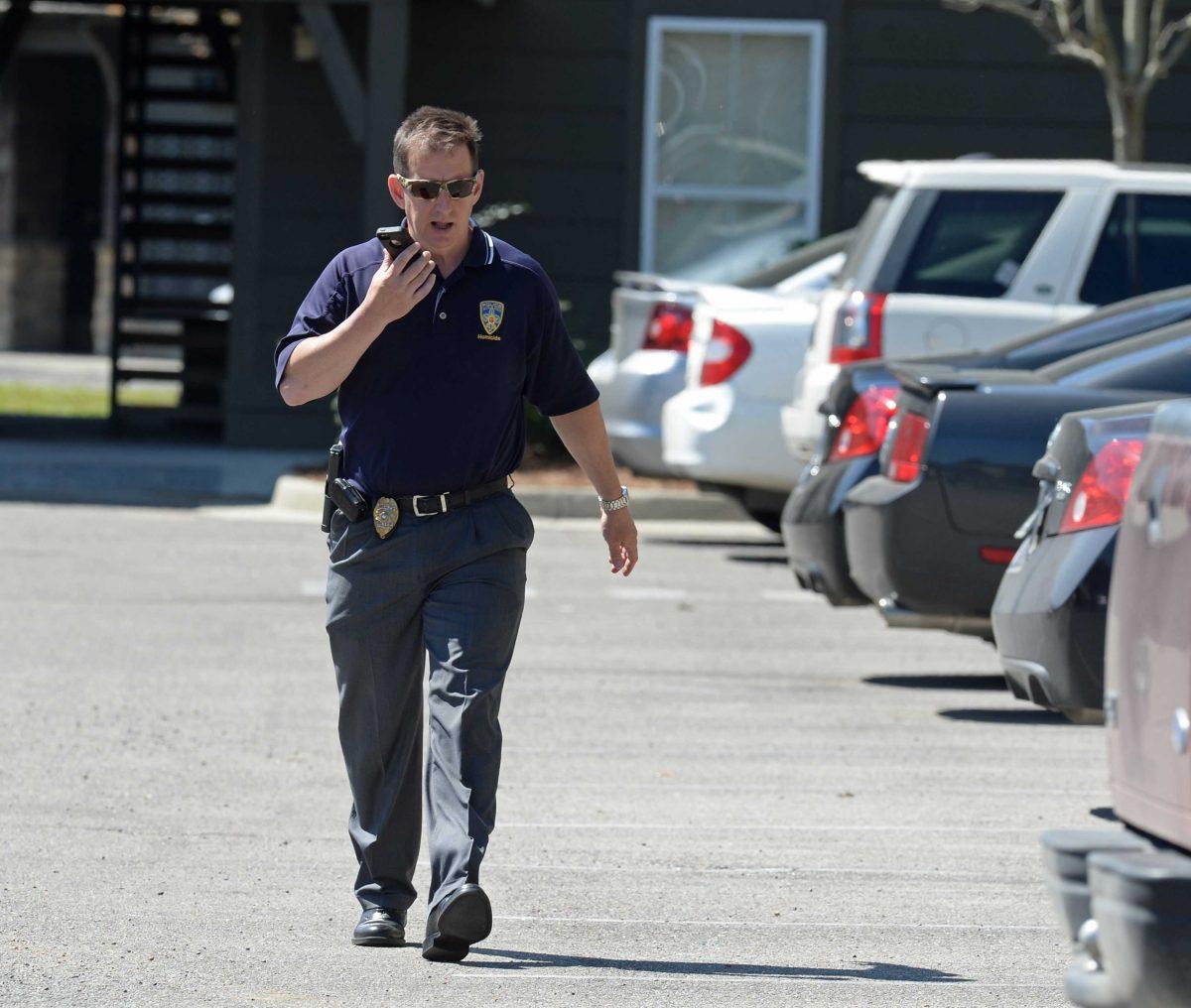 An official investigates the scene where two female Southern University students were killed at The Cottages Apartment Complex in Baton Rouge, La., Sunday, April 10, 2016. Detectives didn't immediately identify any suspects or motives in the shooting, which occurred in a parking lot outside an apartment complex around 2 a.m., said Baton Rouge Police Sgt. Don Coppola Jr. (Patrick Dennis/The Advocate via AP) MAGS OUT; INTERNET OUT; NO SALES; TV OUT; NO FORNS; LOUISIANA BUSINESS INC. OUT (INCLUDING GREATER BATON ROUGE BUSINESS REPORT, 225, 10/12, INREGISTER, LBI CUSTOM); MANDATORY CREDIT