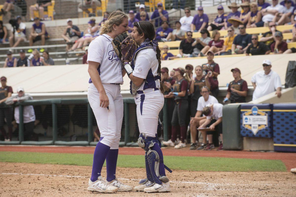 LSU freshman pitcher Carley Hoover (21) and junior catcher Kellsi Kloss (77) talk in between pitches during the Tiger's 1-0 defeat against Arizona St. on Saturday, May 16, 2015 in Tiger Park.