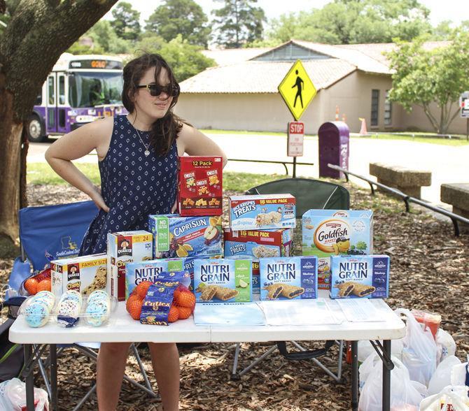 LSU Agriculture College Council Senator, Ariel Bergeron, hands out snacks to students as part of Student Government's Finals Fuel program on April 26, 2016 in the Tureaud Courtyard.