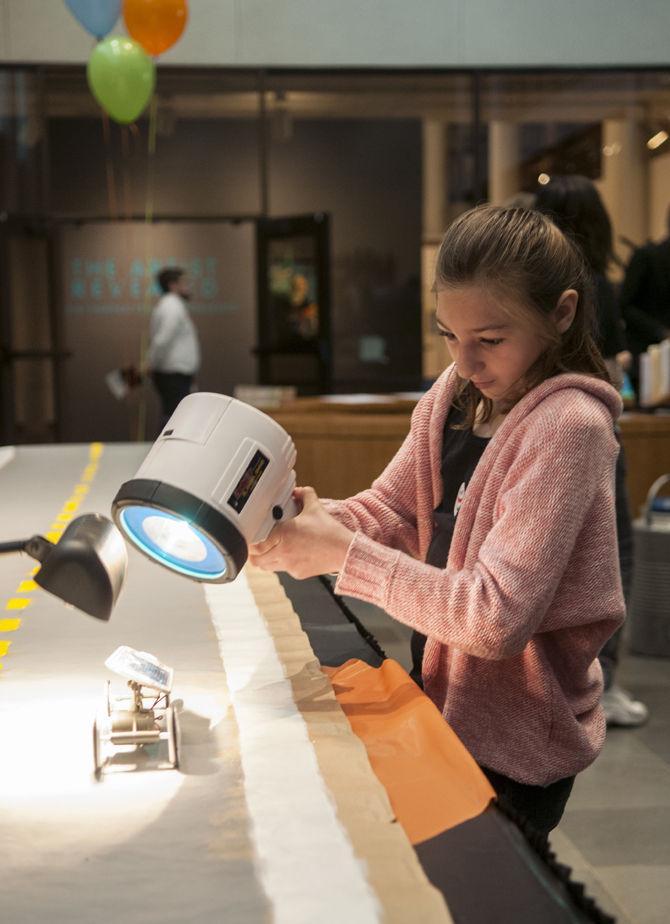 Brooklyn, 9, moves a solar car down the track Saturday, April 2, 2016, as part of an activity presented by ExxonMobil during Engineering Day at the Louisiana Art &amp; Science Museum.