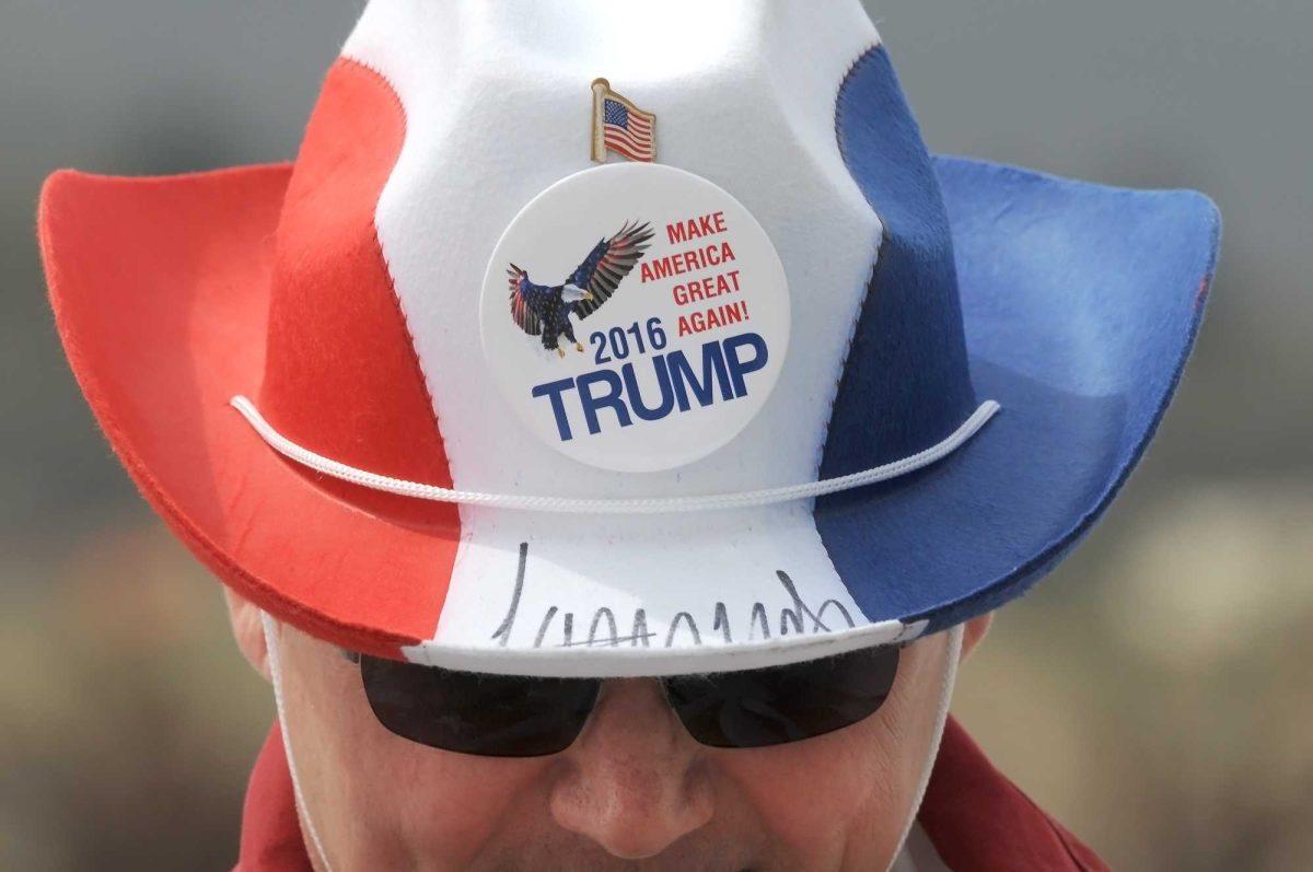 William Malater, of Oswego, N.Y., looks at his cell phone as he waits in line for a rally for Republican Presidential candidate Donald Trump, Monday, April, 25, 2016, in Wilkes-Barre Township, Pa. (Mark Moran/The Citizens' Voice via AP) MANDATORY CREDIT