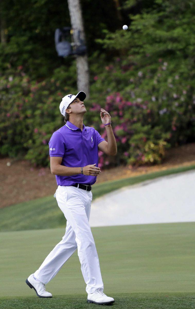 Smylie Kaufman throws his ball in the air as he walks to the 14th tee during the final round of the Masters golf tournament Sunday, April 10, 2016, in Augusta, Ga. (AP Photo/Matt Slocum)