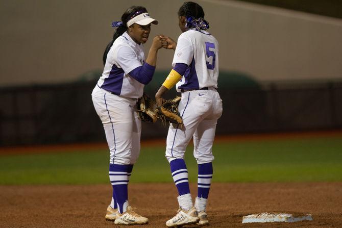 LSU senior infielder Bianka Bell (27) daps junior infielder Constance Quinn (5) during LSU's 6-2 victory against the University of Alabama on March 11, 2016 at Tiger Park