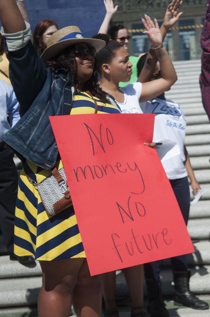 Students who have TOPS raising their hands at a rally to protest potential cuts to higher education funding at the State Capitol Building on Feb. 19,2016.