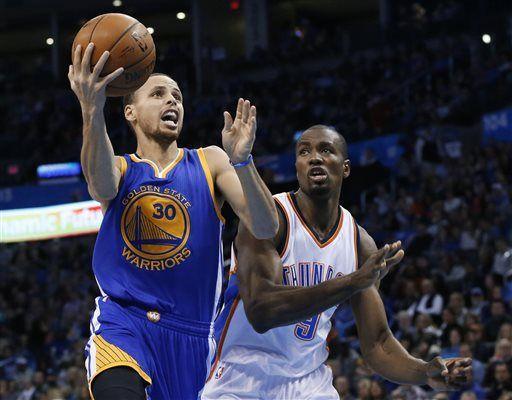 Golden State Warriors guard Stephen Curry (30) goes in for a shot in front of Oklahoma City Thunder forward Serge Ibaka (9) during the second quarter of an NBA basketball game in Oklahoma City, Friday, Jan. 16, 2015. (AP Photo/Sue Ogrocki)