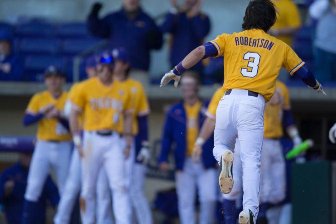 LSU junior infielder Kramer Robertson (3) celebrates his run during LSU's 7-5 victory against the University of Alabama on Sunday, March 20, 2016 at Alex Box Stadium.