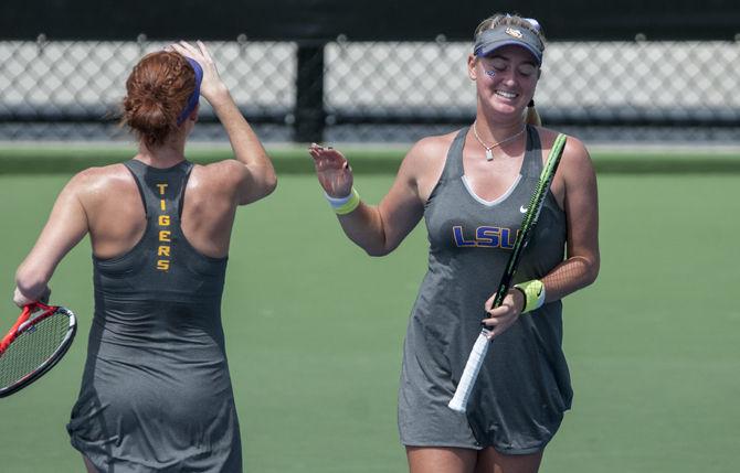 LSU sophomore Ryann Foster high fives partner junior Abby Owens during the Tigers' 4-3 victory against Kentucky in the SEC Championship on Thursday, April 21, 2016 at the LSU Tennis Complex.