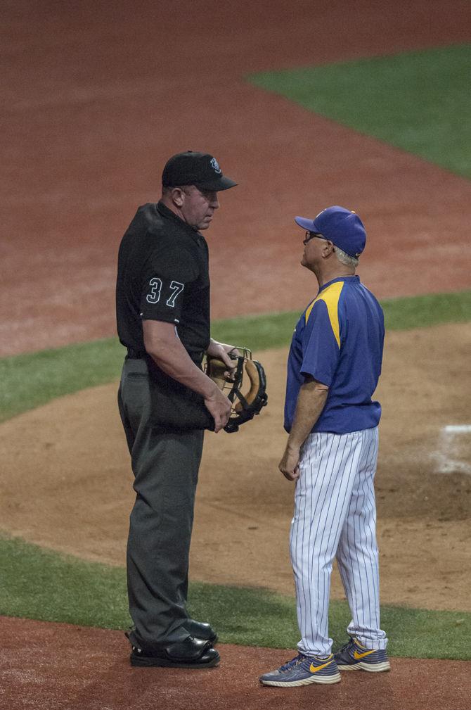 LSU head coach Paul Mainieri converses with an umpire during the Tigers' game against Southeastern on April 20, 2016 in Alex Box Stadium