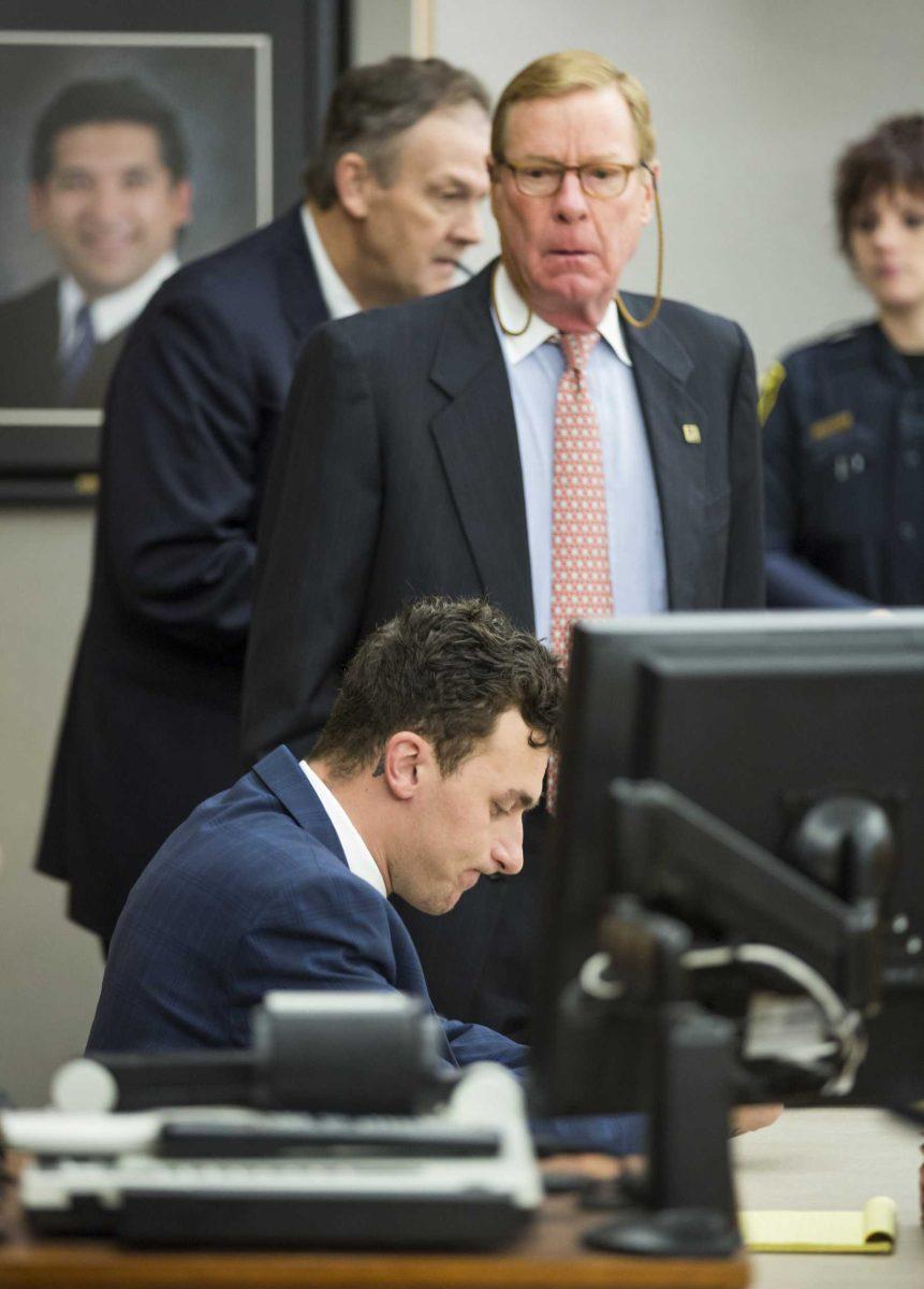 FILE - In this May 5, 2016 file photo, former Cleveland Browns quarterback Johnny Manziel sits at the defense table as his attorney Bob Hinton, center, looks on during a hearing, in Dallas. Hinton accidentally texted The Associated Press Wednesday, June 22, and confirmed he is seeking a plea deal in Manziel's domestic violence case, but has doubts about the quarterback&#8217;s ability to stay clean. (Smiley N. Pool/The Dallas Morning News via AP, Pool)