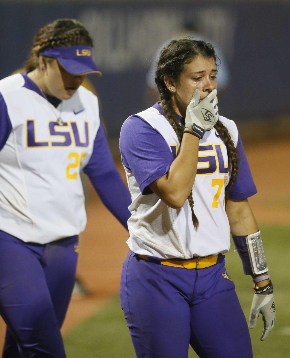 LSU catcher Kellsi Kloss, right, cries after Oklahoma defeated LSU in an NCAA Women's College World Series softball game in Oklahoma City, Monday, June 6, 2016. Oklahoma won 7-3. (AP Photo/Sue Ogrocki)