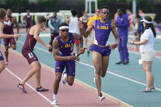 LSU junior LaMar Bruton (right) passes the baton to senior Morgan Wells (left) during the Battle of the Bayou on Saturday, April 9, 2016 at Skip Bertman Stadium