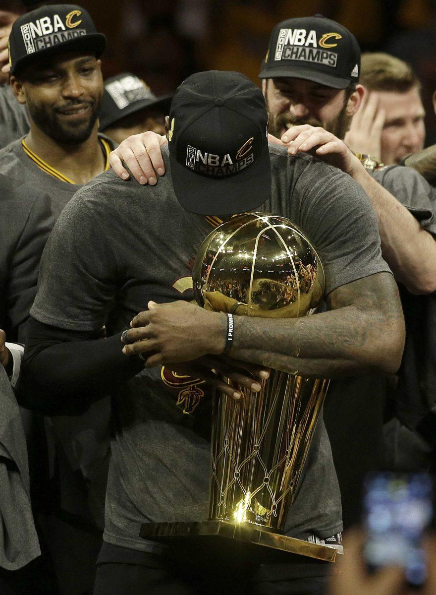 Cleveland Cavaliers forward LeBron James, center, celebrates with teammates after Game 7 of basketball's NBA Finals against the Golden State Warriors in Oakland, Calif., Sunday, June 19, 2016. The Cavaliers won 93-89. (AP Photo/Marcio Jose Sanchez)