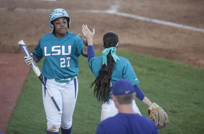 LSU senior infielder Bianka Bell (27) high fives senior infielder Sandra Simmons (3) during the Tigers' 8-0 victory against South Carolina on Saturday, April 23, 2016 in Tiger Park.