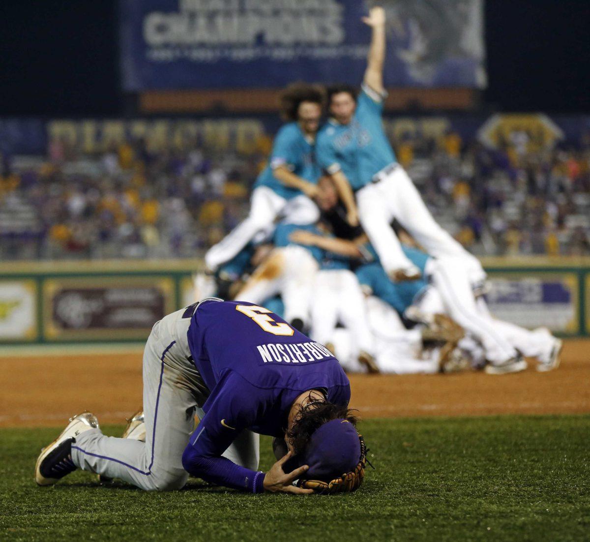 LSU shortstop Kramer Robertson (3) reacts as Coastal Carolina celebrates after LSU lost in the bottom if the ninth inning of an NCAA college baseball tournament super regional game in Baton Rouge, La., Sunday, June 12, 2016. Coastal Carolina advanced to the College World Series. (AP Photo/Gerald Herbert)