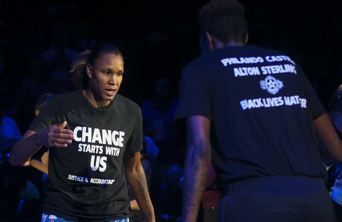 Minnesota Lynx forward Rebekkah Brunson (32) is greeted by Minnesota Lynx forward Natasha Howard (3) while starting lineups are announced at the Target Center on Saturday, July 9, 2016. Lynx players did not wear T-shirts supporting the Black Lives Matter movement ahead of Tuesday's game in San Antonio after four off-duty police officers walked away from security jobs at a Lynx game over the weekend because of the T-shirts. (Timothy Nwachukwu/Star Tribune via AP)