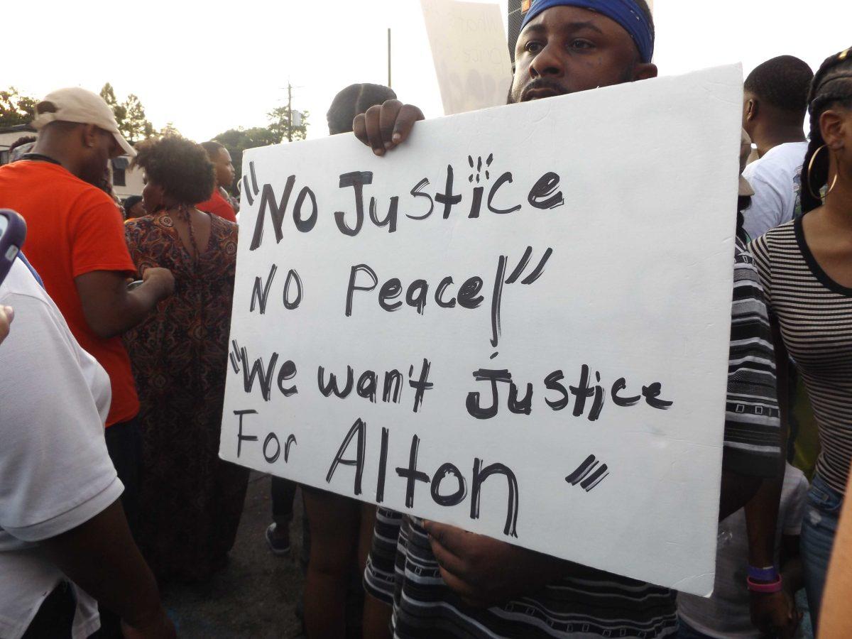 Protesters took to the street Wednesday, July 6, for a vigil for Alton Sterling outside the&#160;Triple S Food Mart where he was fatally shot by police officers early Tuesday morning.