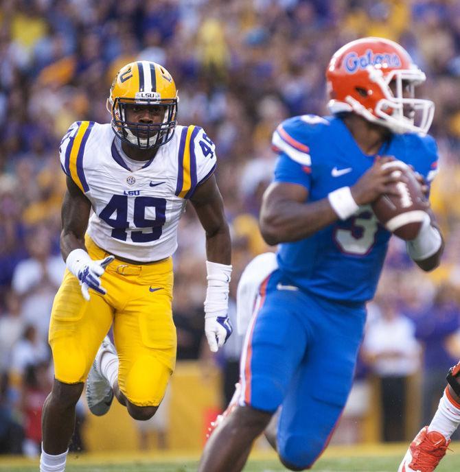 LSU defensive end Arden Key (49) rushes towards Florida sophomore quarterback Treon Harris (3) on Saturday, Oct. 17, 2015, during the Tigers' 35-28 victory against the Gators in Tiger Stadium.