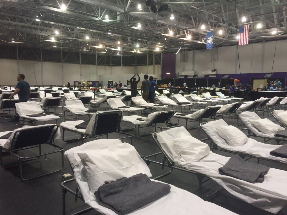 Students from Residential Life, the LSU Panhellenic Council, LSU Ambassadors&#160;and Student Government&#160;set up cots for&#160;Department of Health and Hospitals medical special needs shelter in the Field House on August 14, 2014.