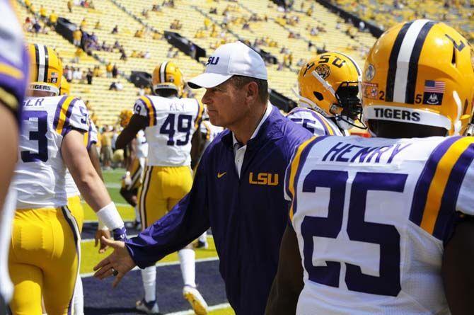 LSU football coach Les Miles shakes the hands of the players as they enter the stadium agaisnt Auburn on Saturday Sept. 19, 2015, in Tiger Stadium.