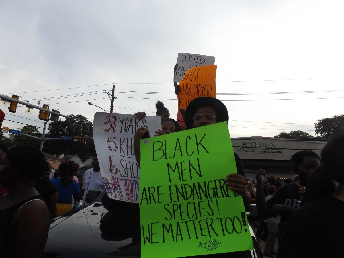 Protesters took to the street Wednesday, July 6, for a vigil for Alton Sterling outside the&#160;Triple S Food Mart where he was fatally shot by police officers early Tuesday morning.