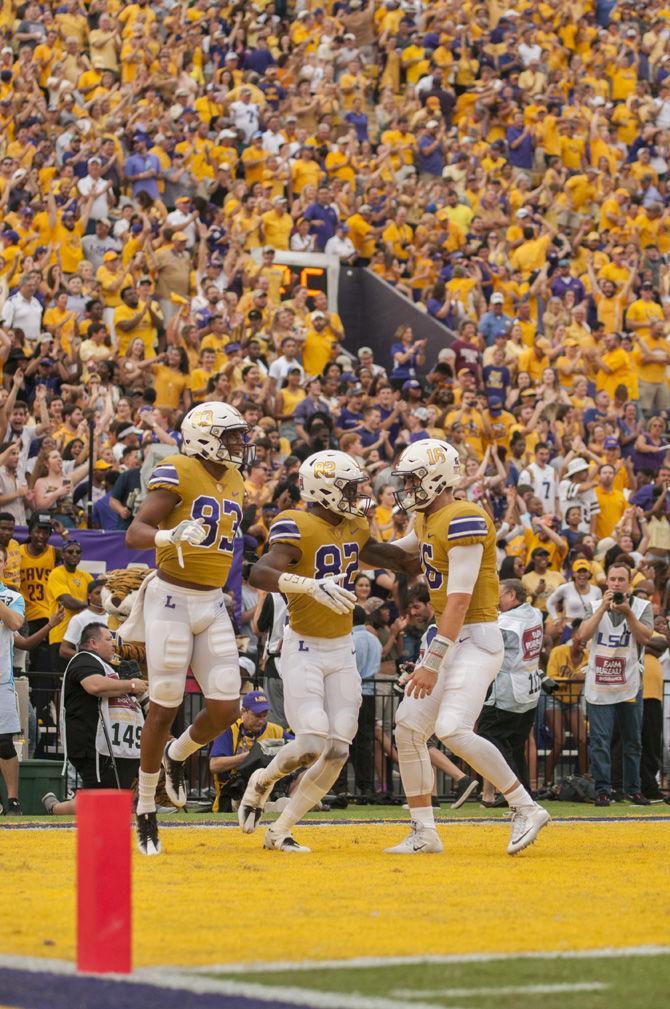 LSU junior quarterback Danny Etling (16), junior wide reciever D.J. Chark (82) and senior wide reciever Travin Dural (83) celebrate a touchdown during the Tigers 23-20 victory over Mississippi State on Sept. 17, 2016 at Tiger Stadium.