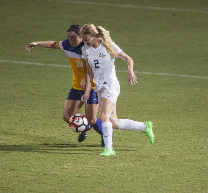 LSU junior forward Delaney Sheehan defends against George Washington University redshirt junior midfielder Ivana Szwejkowski (2) during Tigers 1-3 loss onThursday Aug. 25, 2016.