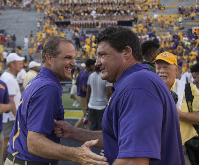 LSU defensive coordinator Kevin Steele shakes hands with defensive line coach Ed Orgeron during the Tigers&#8217; 45-21 victory against Auburn on Saturday, Sept. 19, 2015 in Tiger Stadium