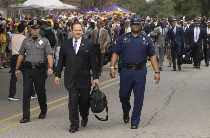 Coach Les Miles walks down North Stadium Road towards Tiger Stadium on Saturday Sept. 17, 2016, as he and his Tigers prepare to face off against Mississippi State University. The LSU victory ended with a score of 23-20.