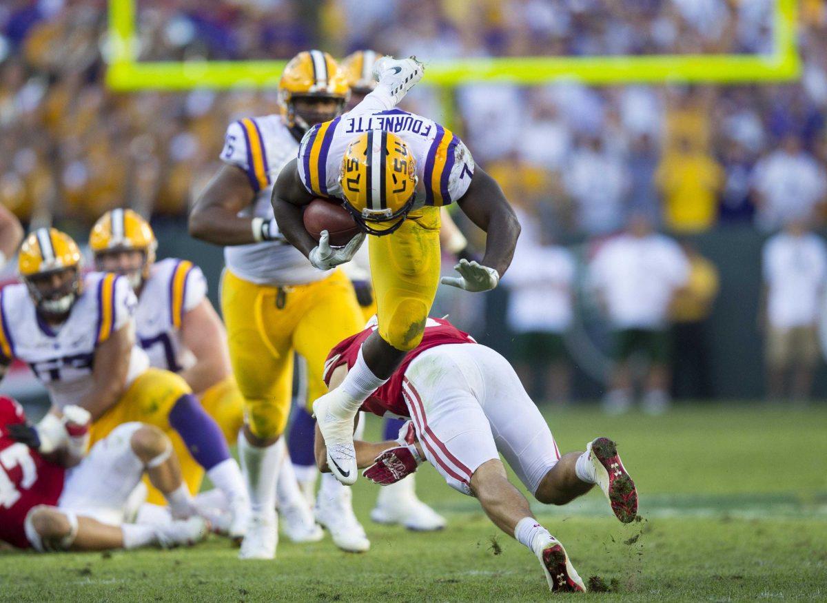 Sep 3, 2016; Green Bay, WI, USA; LSU Tigers running back Leonard Fournette (7) is upended by Wisconsin Badgers safety Leo Musso (19) during the fourth quarter at Lambeau Field. Mandatory Credit: Jeff Hanisch-USA TODAY Sports