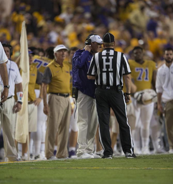 LSU head coach Les Miles speaks with an official during the Tigers 23-20 victory over Mississippi State on Sept. 17, 2016 at Tiger Stadium.