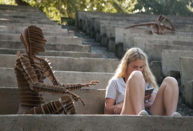 LSU architecture freshman Gracie Jones reads a book with her life-sized "clone" she built on Sept. 12, 2016, in the Greek Amphitheater.