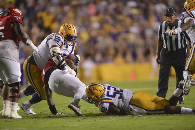 LSU sophomore nose tackle Travonte Valentine (55) and senior linebacker Kendell Beckwith (52) tackle Jacksoneville State senior quarterback Eli Jenkins (7) during the 34-13 win against the Jacksonville Gamecocks on Saturday Sept. 10, 2016, in Tiger Stadium.