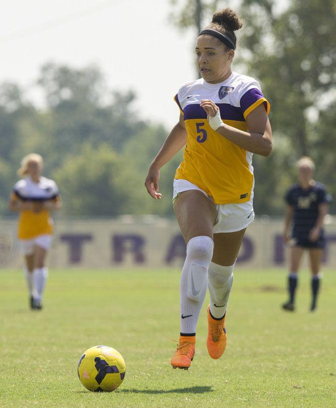 LSU sophomore forward Jorian Baucom (5) dribbles the ball down the field on Sunday, Sept. 20, 2015 during the Tigers&#8217; 5-1 win against Marquette University at LSU Soccer Stadium.