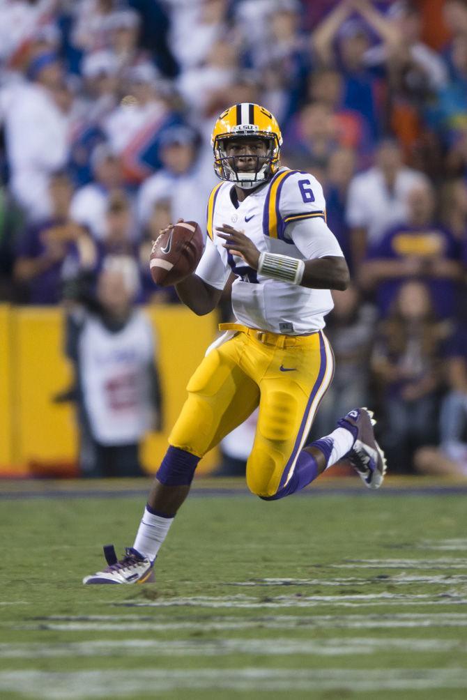 <p>LSU sophomore quarterback Brandon Harris (6) runs the ball down the field on Saturday, Oct. 17, 2015, during the Tigers' 35-28 victory against Florida in Tiger Stadium.</p>