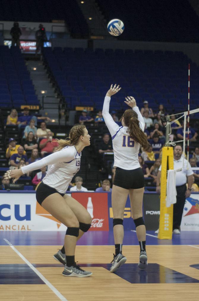 LSU sophomore setter Lindsay Flory (16) sets the ball for freshman middle blocker Jacqui Armer (13) during the Tigers' 0-3 loss against the University of Arkansas on September 25, 2016 in the Pete Maravich Assembly Center.