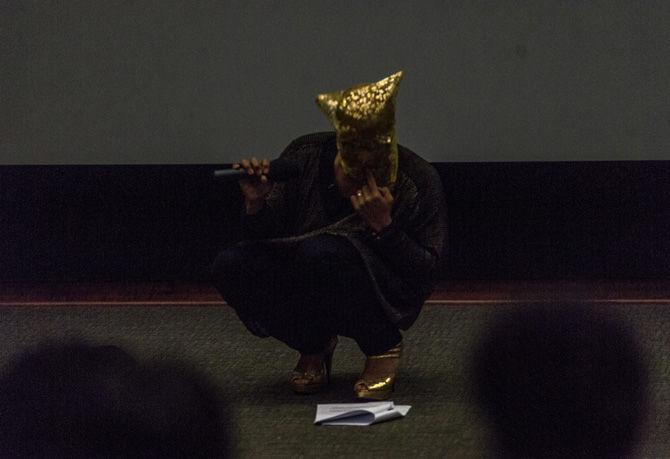 Award-winning poet Ronaldo Wilson adjusts his mask while reciting a poem during the 'From Lucy to Land, Mirinkai and Then' performance on Sept. 15, 2016, at the LSU Digital Media Center Theater.