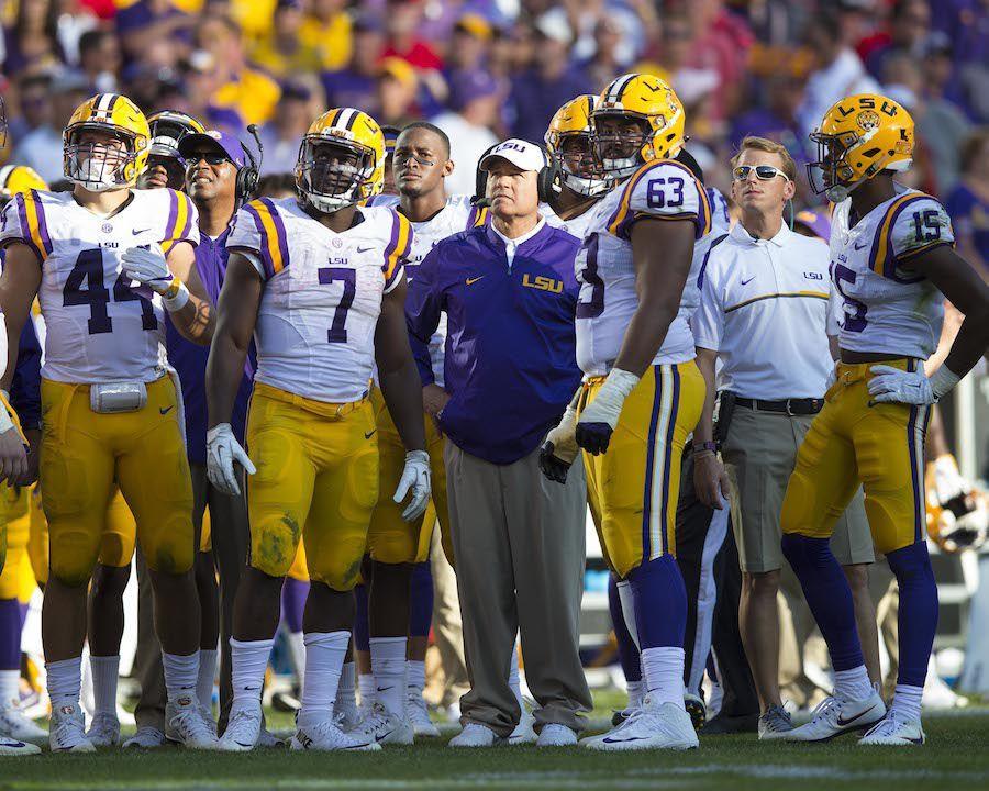 Sep 3, 2016; Green Bay, WI, USA; LSU Tigers head coach Les Miles looks to the scoreboard surrounded by players during the fourth quarter against the Wisconsin Badgers at Lambeau Field. Mandatory Credit: Jeff Hanisch-USA TODAY Sports