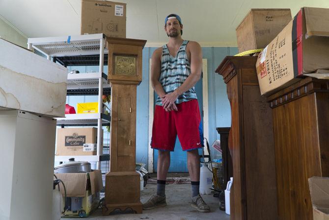 University mechanical engineering junior Nick Holt works on gutting his family home after recent flooding in Baton Rouge.&#160;