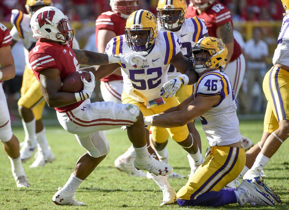 Sep 3, 2016; Green Bay, WI, USA; Wisconsin Badgers running back Corey Clement (6) tries to get past LSU Tigers defensive end Tashawn Bower (46) and linebacker Kendell Beckwith (52) in the fourth quarter at Lambeau Field. Mandatory Credit: Benny Sieu-USA TODAY Sports